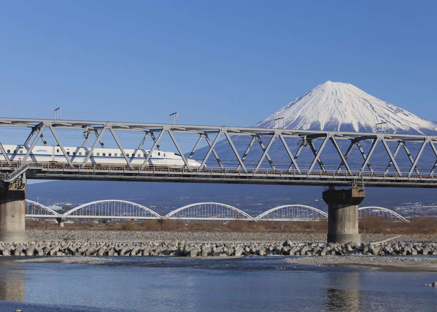 Bullet train passing Mount Fuji