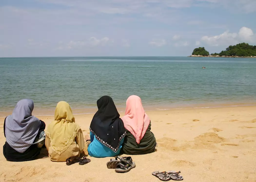 Local women relax on the beach, Langkawi
