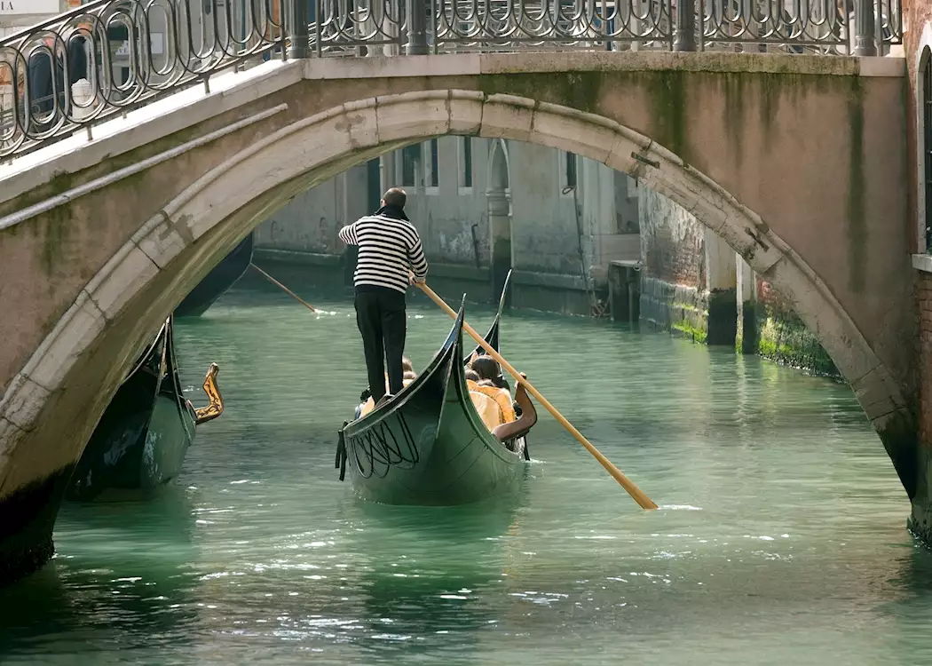 Gondola under old bridge, Venice
