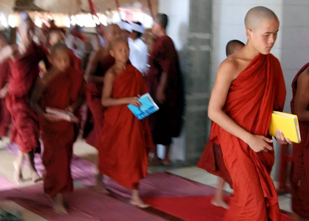 Novice monks walk to exams in the grounds of a temple at Nyaung Shwe