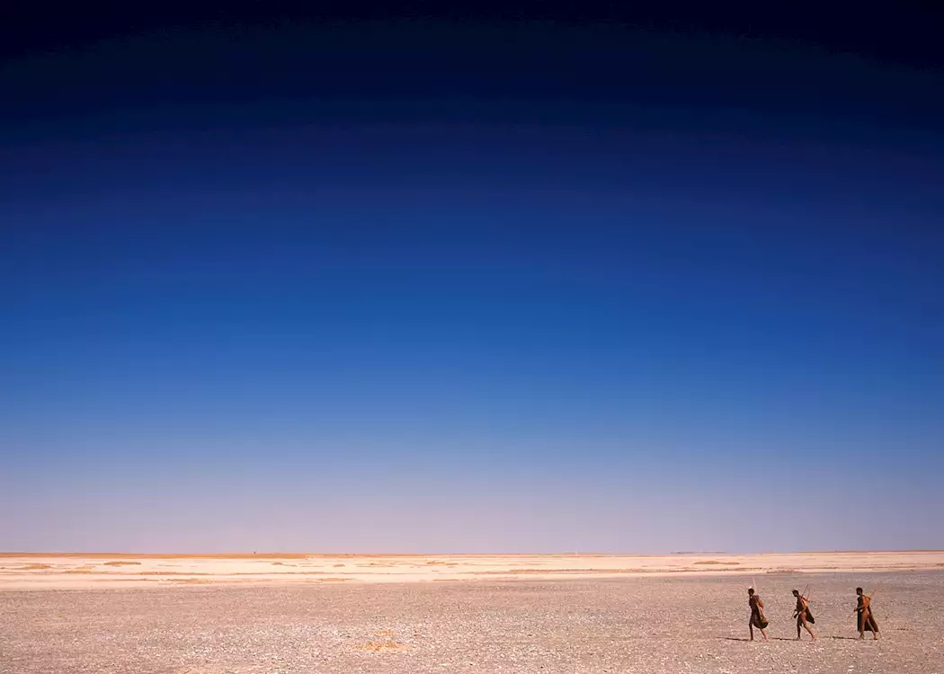 Bushmen walking across the Makgadikgadi Pans