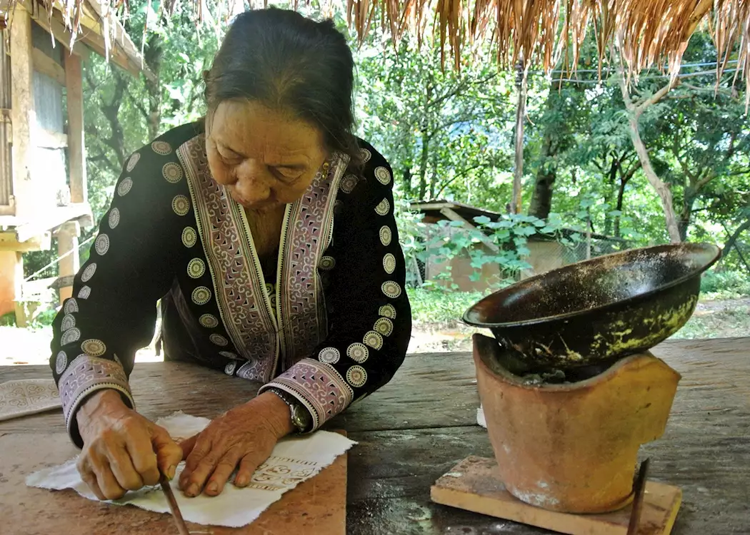 Lady showing the technique for Batik, Chiang Khong, Thailand