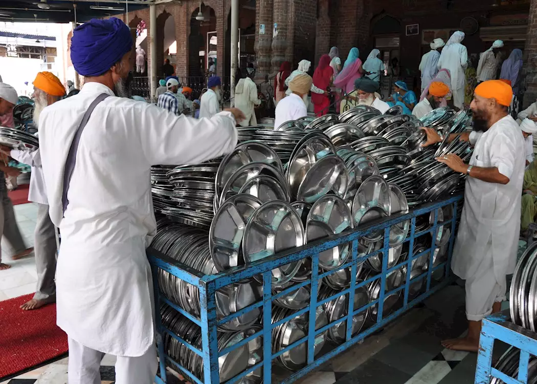 Volunteers stacking thali plates at the Golden Temple, Amritsar