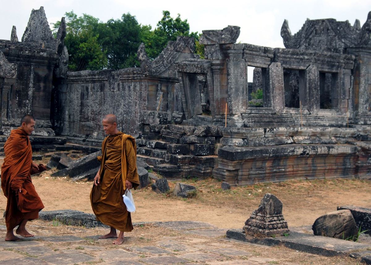 Buddhist monks walk alongside the central sanctuary at Preah Vihear Buddhist monks walk alongside the central sanctuary at Preah Vihear