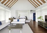 The living room of a one bedroom water villa at COMO Cocoa Island
