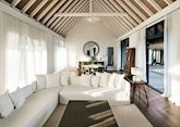 A water villa living room at COMO Cocoa Island