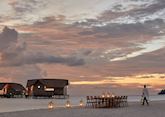 Beach dining at sunset, COMO Cocoa Island