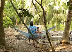 Locals sitting on a Hammock in the Mekong Delta