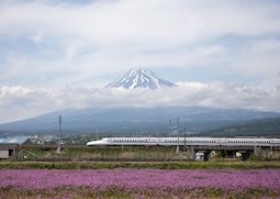 Bullet train passing by Mount Fuji