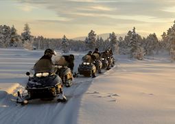 Morning snowmobile tour with hearty log cabin breakfast