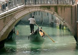 Gondola under old bridge, Venice