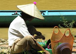 Iban woman preparing lunch for the longhouse, Lemanak River, Sarawak