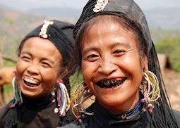 Women of the Ann tribe paint their teeth black