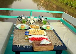 Open Deck breakfast on the Deluxe Klotok Boat