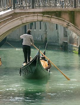 Gondola under old bridge, Venice