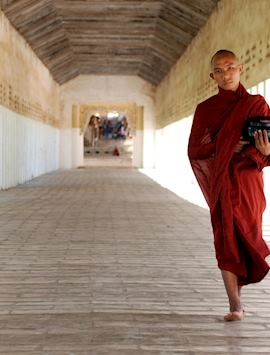 A novice monk returns from the Shwezigan Pagoda with alms in Bagan