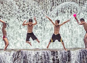 Children playing at the dam in Bali Indonesia Children playing at the dam in Bali Indonesia