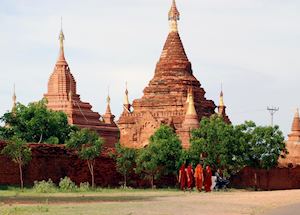 Monks walk in Bagan during early evening Monks walk in Bagan during early evening