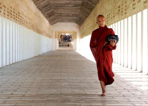A novice monk returns from the Shwezigan Pagoda with alms in Bagan A novice monk returns from the Shwezigan Pagoda with alms in Bagan