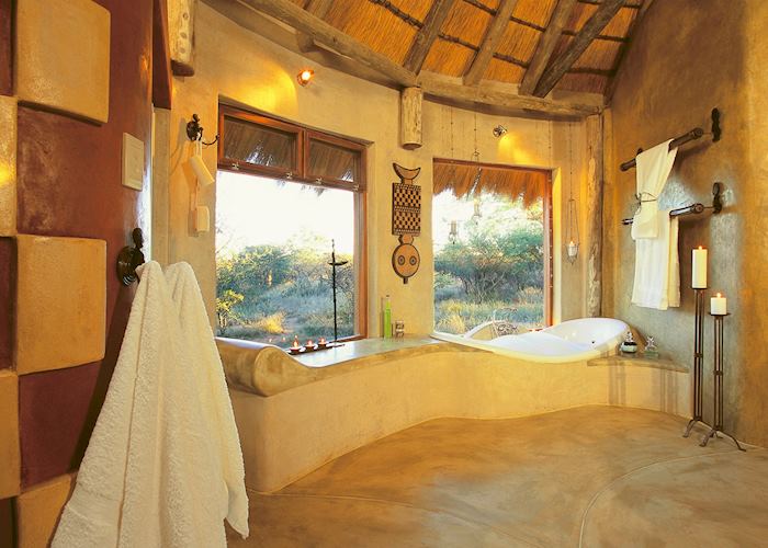 A bathroom with a view at the Okonjima Bush Suite, Central Highlands