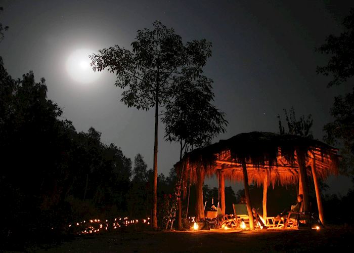 Guests enjoying the campfire during their stay at Shergarh