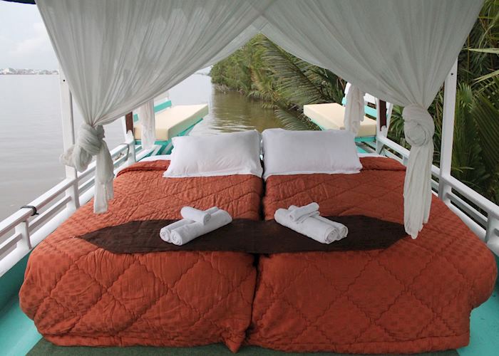 Upper deck double bed on Deluxe Klotok Boat