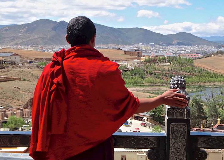Monk looking out at the view over Songzanlin Monastery in Shangri-la