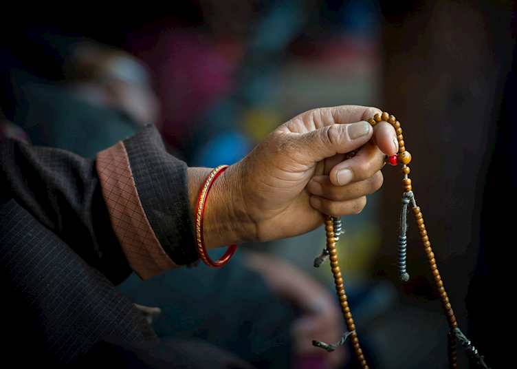 Tibetan Buddhist with his prayer beads