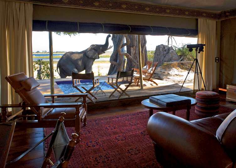 Visitors outside suite at Zarafa Camp