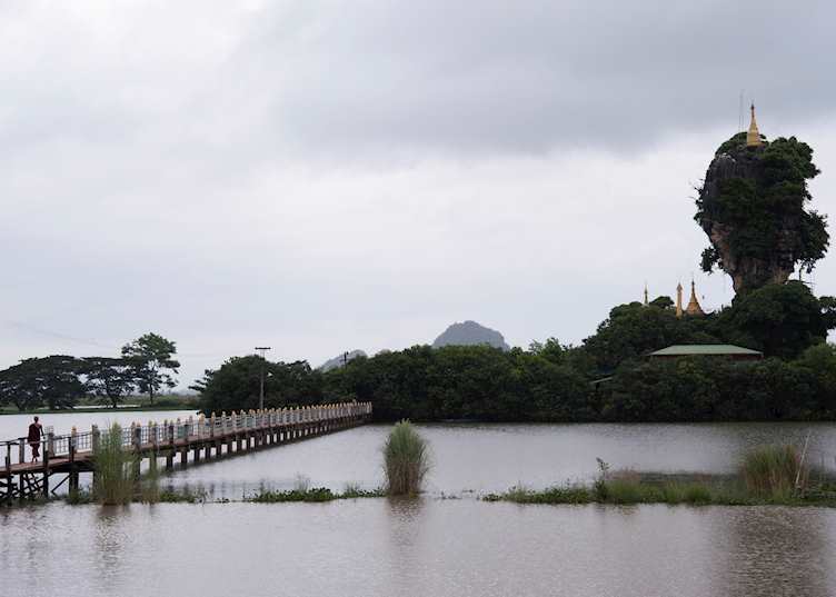 A monk walks to Kyauk Ka Lat Temple, Hpa-An