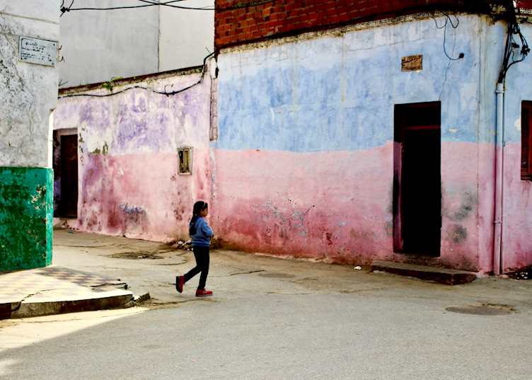 A young girl walking through the streets of Asilah