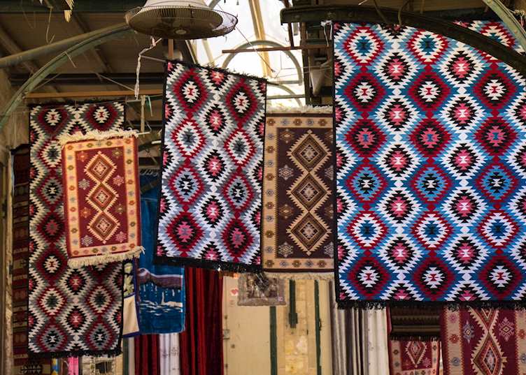 Rugs for sale in a souq market, Nazareth