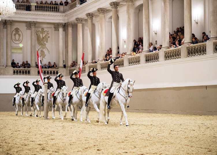 The horses and riders entering the floor