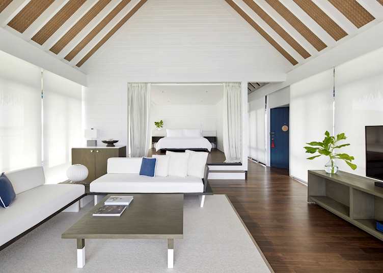 The living room of a one bedroom water villa at COMO Cocoa Island