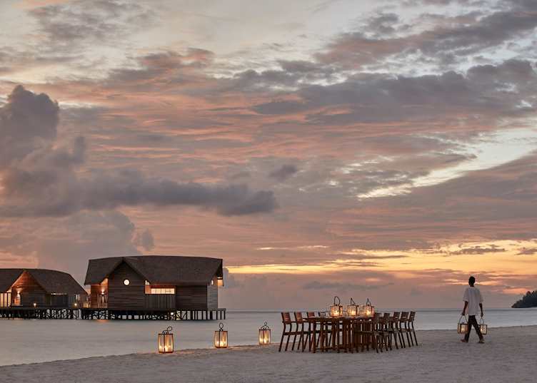 Beach dining at sunset, COMO Cocoa Island