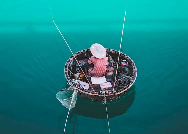 Fisherman on a circle boat in Lang Co