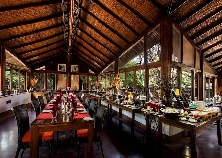 The beautiful indoor dining space at Reni Pani Jungle Lodge