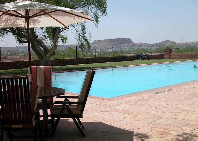 Swimming pool at Umaid Bhawan Palace with a view of Mehrangarh fort