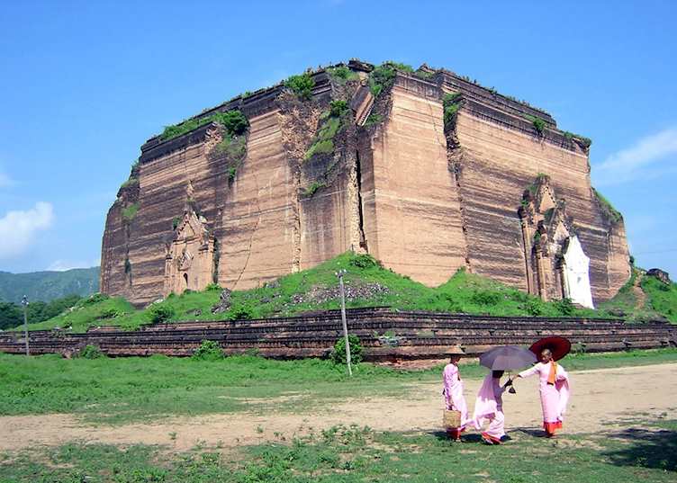 Nuns walk past the cracked and unfinished Mingun Pagoda