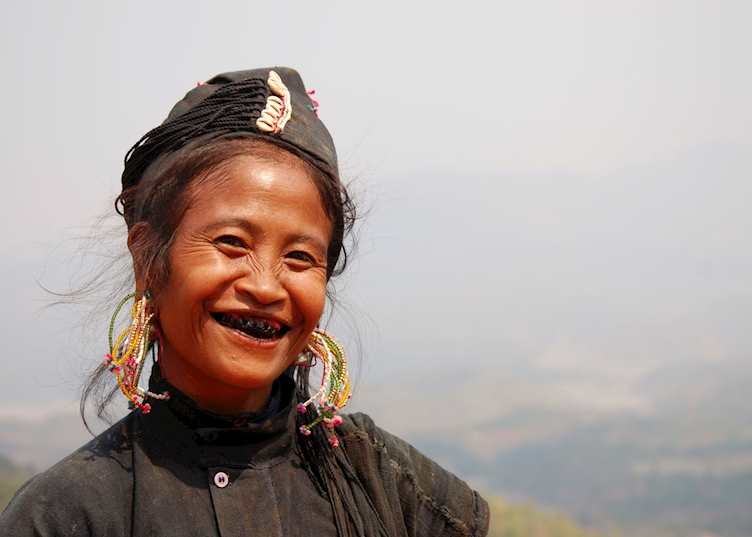 Women of the Ann tribe paint their teeth black