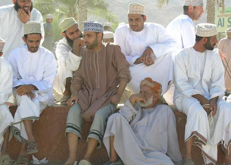 Men at Nizwa cattle market, Oman