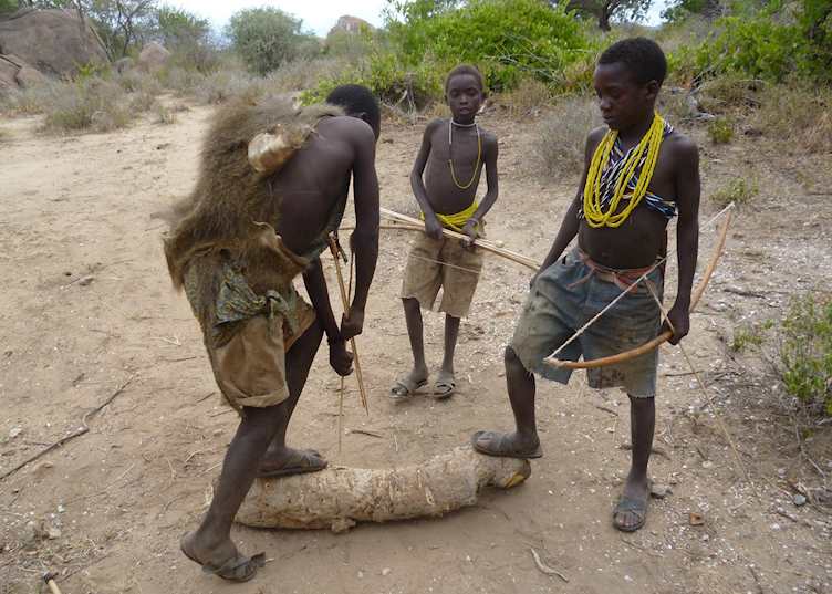 Young Hadzabe boys practice their shooting skills, Lake Eyasi, Tanzania
