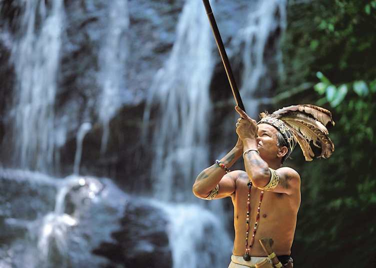 Iban tribesman with blowpipe, Batang Ai, Sarawak