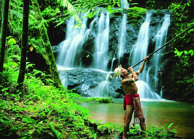 Iban Headhunter with traditional blowpipe, Batang Ai, Malaysian Borneo