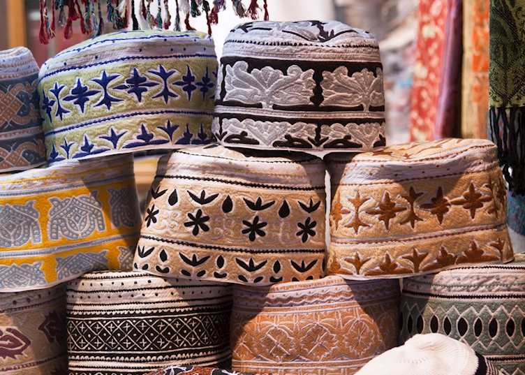 Men's caps in souq, Muscat
