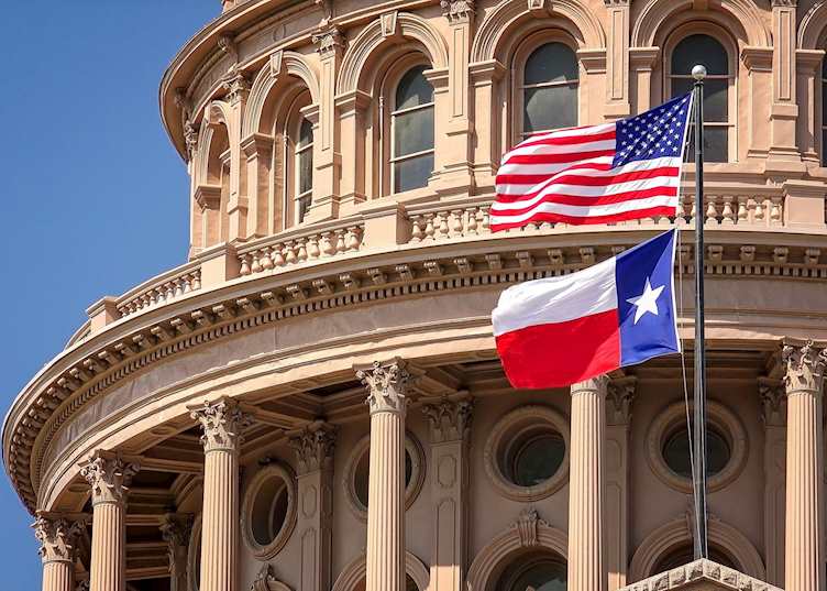 American and Texas flags flying, Texas State Capitol in Austin