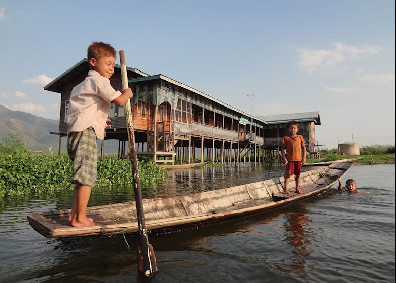Kids attempting the one-legged rowing technique on Inle Lake Kids attempting the one-legged rowing technique on Inle Lake
