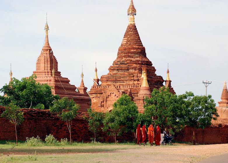 Monks walk in Bagan during early evening