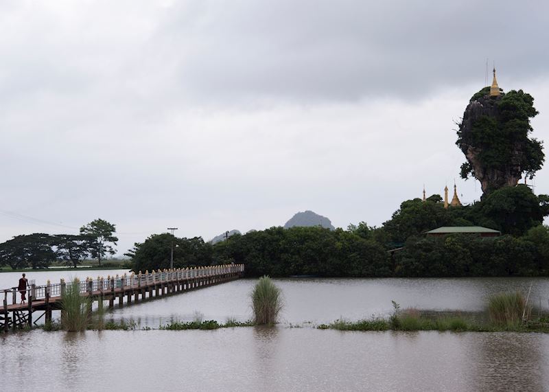 A monk walks to Kyauk Ka Lat Temple, Hpa-An