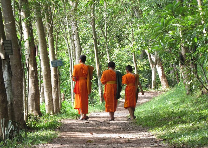 Monks walking by Mount Phousi